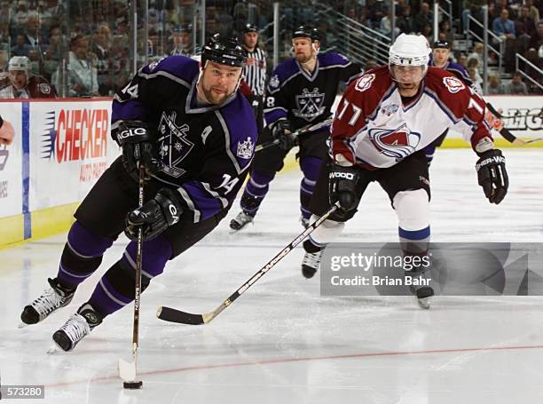 Mattias Norstrom of Los Angeles Kings skates past Ray Bourque of the Colorado Avalanche in the third period of their Western Conference semifinal...