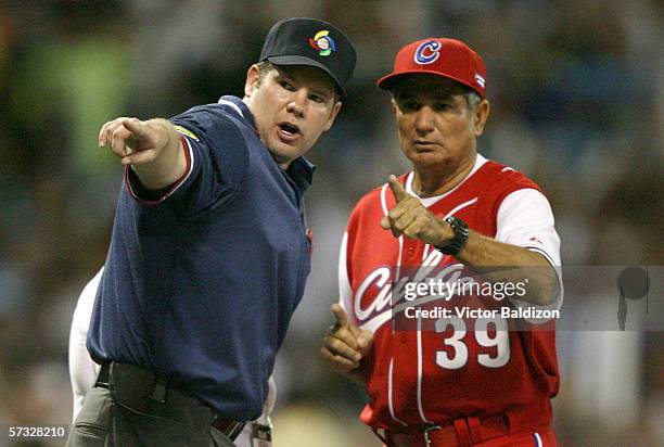 Manager Higinio Velez of Cuba speaks with an umpire during the game against Puerto Rico on March 15, 2006 at Hiram Bithorn Stadium in San Juan,...