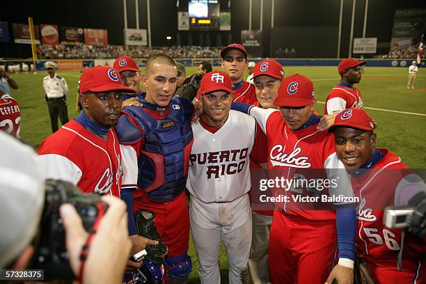 Ivan Rodriguez of Puerto Rico is pictured with members of Team Cuba after the game on March 15, 2006 at Hiram Bithorn Stadium in San Juan, Puerto...