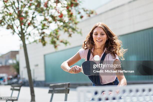 young woman playing table tennis - tischtennis stock-fotos und bilder