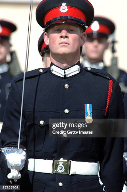 Prince Harry stands to attention at his passing-out Sovereign's Parade at Sandhurst Military Academy on April 12, 2006 in Sandhurst, England.