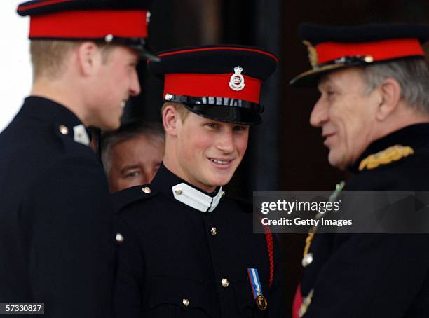 Prince Harry looks on at Prince William and General Sir Michael Jackson as they chat at the passing-out Sovereign's Parade at Sandhurst Military...