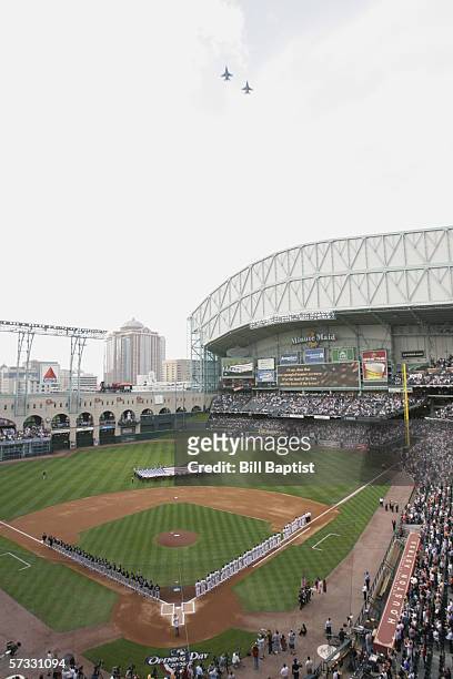Giant US Flag is displayed as jets fly over the stadium before the Opening Day game between the Houston Astros and the Florida Marlins at Minute Maid...