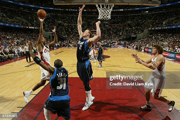 Damon Jones of the Cleveland Cavaliers shoots over Jason Terry and Dirk Nowitzki of the Dallas Mavericks during the game on March 29, 2006 at The...