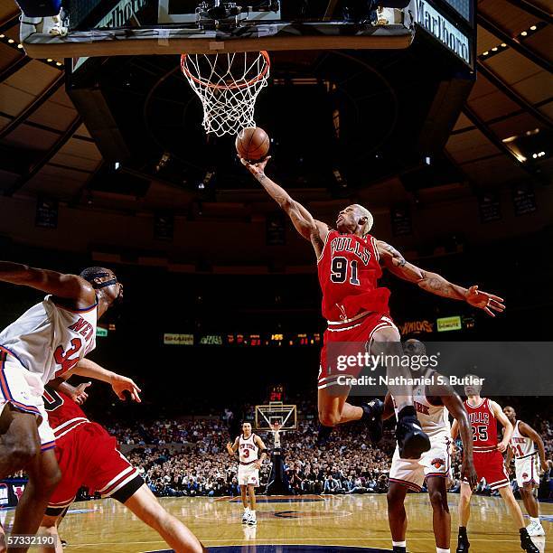 Dennis Rodman of the Chicago Bulls grabs a rebound against Charles Oakley of the New York Knicks during Game Three of the Eastern Conference...