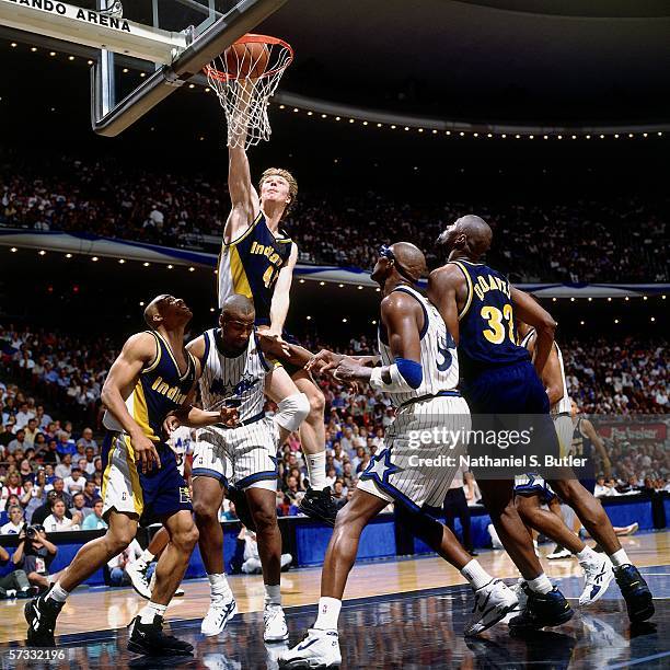 Rick Smits of the Indiana Pacers slam dunks against Dennis Scott of the Orlando Magic during Game One of the Eastern Conference Semifinals at the...