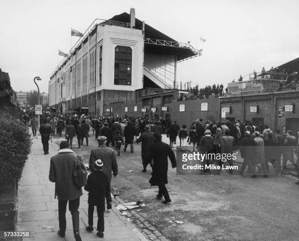 Fans arrive at the Arsenal football ground in Highbury for a match against Everton, 1st January 1972.