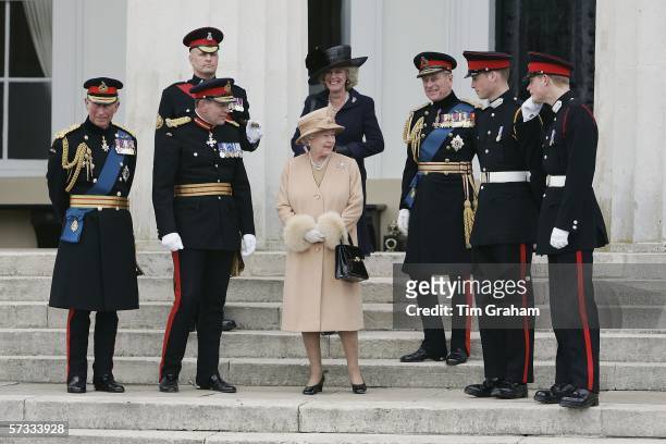 Prince Harry and Prince William stand on the steps of the Old College at Sandhurst Military Academy after the Sovereign's Parade with Prince Charles,...