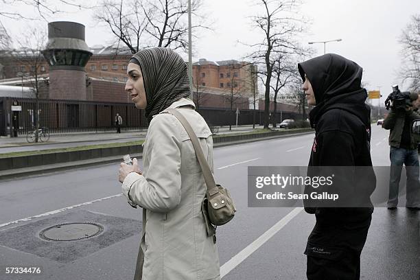 Arsu and Songol Surucu, sisters of Alpaslan and Mutlu Surucu, cross a street while waiting for their two brothers outside a Berlin courthouse after a...