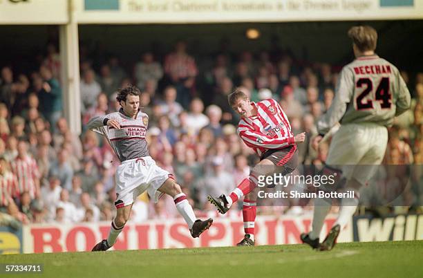 Matthew Le Tissier of Southampton shoots at goal as Ryan Giggs of Manchester United makes a challenge during the FA Carling Premiership match between...