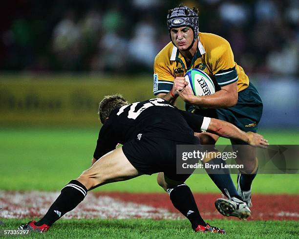 Carl Anderson of New Zealand tackles Brett Gillespie of Australia during the IRB Under 19s World Championship Pool A game between New Zealand and...