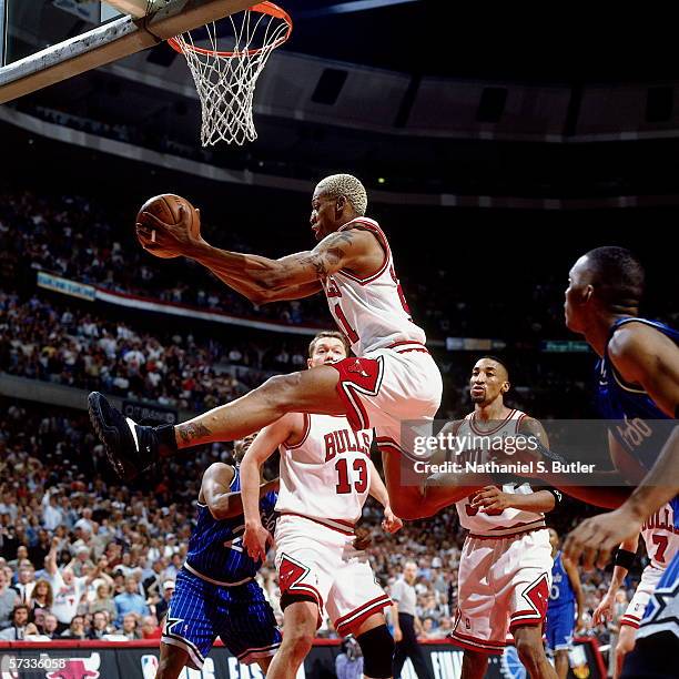 Dennis Rodman of the Chicago Bulls grabs a rebound against Nick Anderson of the Orlando Magic during Game Two of the Eastern Conference Semifinals at...