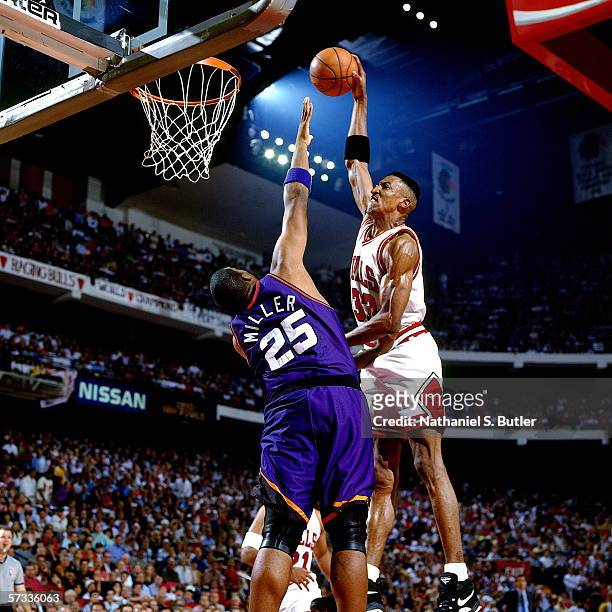 Scottie Pippen of the Chicago Bulls dunks against Oliver Miller of the Phoenix Suns during Game Three of the NBA Finals at the United Center on June...