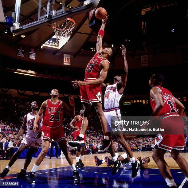 Scottie Pippen of the Chicago Bulls attempts a shot against Anthony Bonner of the New York Knicks during Game One of the Eastern Conference...