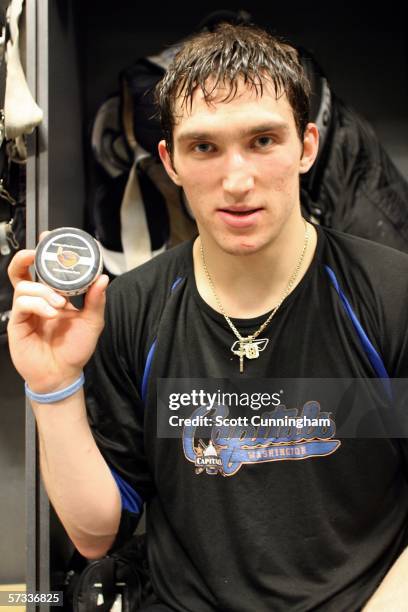 Alexander Ovechkin of the Washington Capitals poses with the puck he scored for his 50th goal of the season in a game against the Atlanta Thrashers...