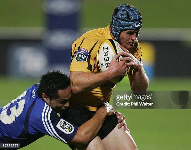Josh Graham of the Western Force is tackled by Ben Atiga of the Blues during the round ten Super 14 match between the Blues and the Western Force at...