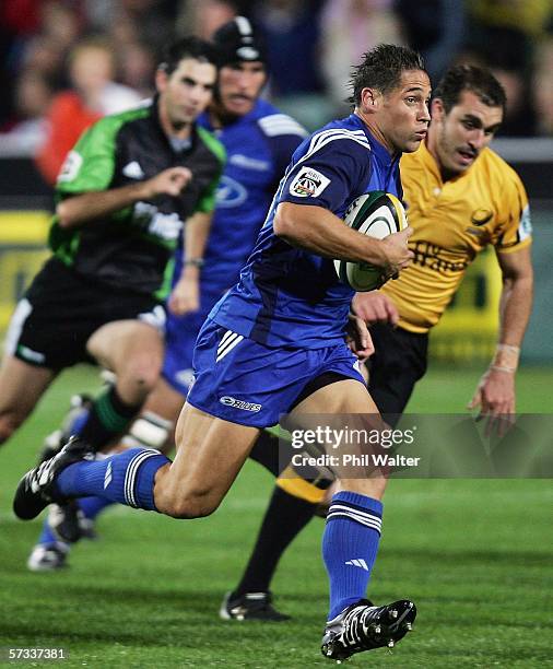 Luke McAlister of the Blues makes a break on the way to scoring a try during the round ten Super 14 match between the Blues and the Western Force at...