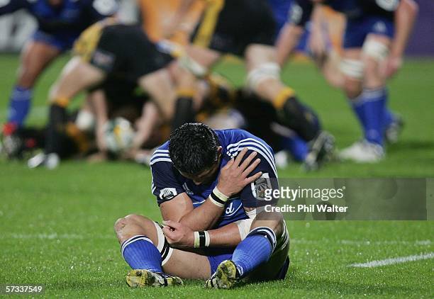 Troy Flavell of the Blues holds his injured shoulder on the field during the round ten Super 14 match between the Blues and the Western Force at...