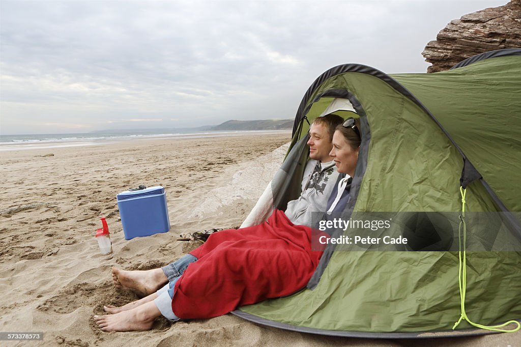 Couple in tent on beach