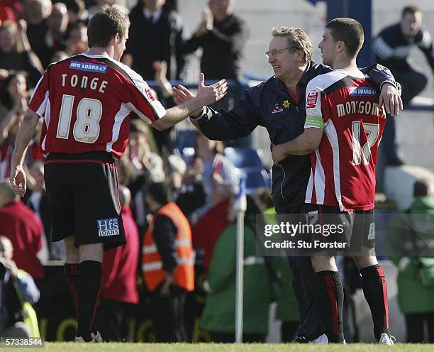 Sheffield manager Neil Warnock celebrates on the final whistle with Michael Tongue and Nick Montgomery of Sheffield United after the Coca Cola league...