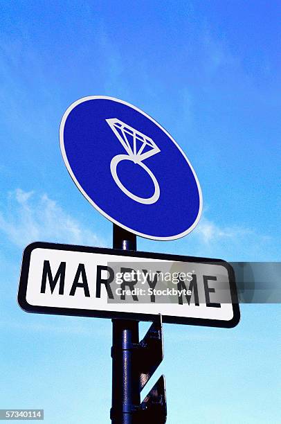 Low Angle View Of A Road Sign Saying Marry Me High-Res Stock Photo