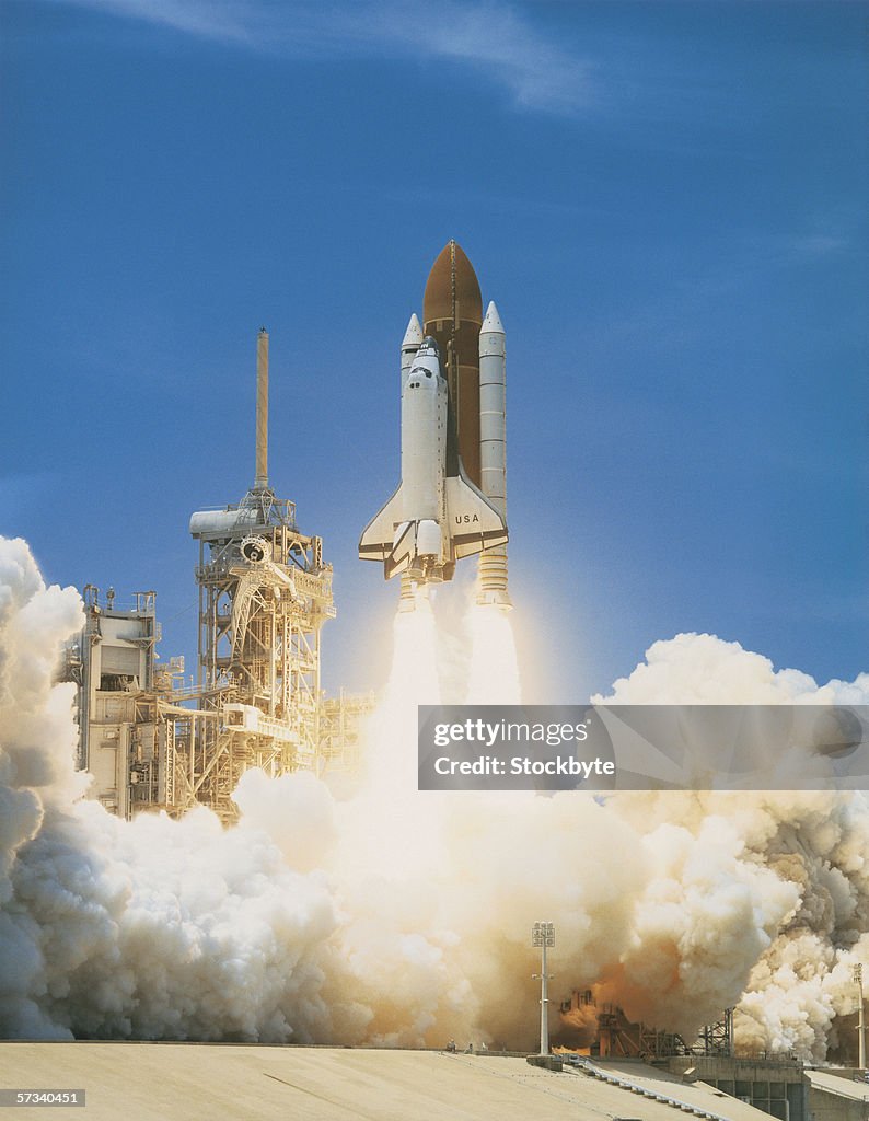Space shuttle taking off from a launch pad