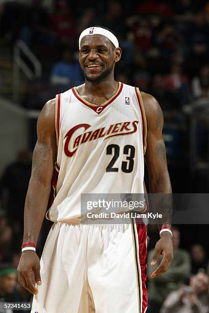 LeBron James of the Cleveland Cavaliers smiles as looks on during a game against the Boston Celtics at Quicken Loans Arena on March 24, 2006 in...