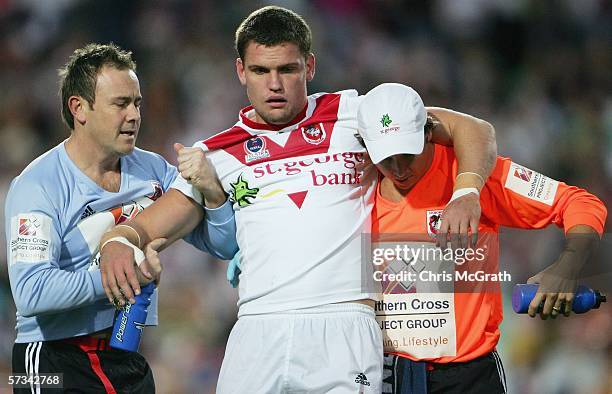 Corey Payne of the Dragons gets attention from trainers after being knocked out during the round six NRL match between the Manly Warringah Sea Eagles...