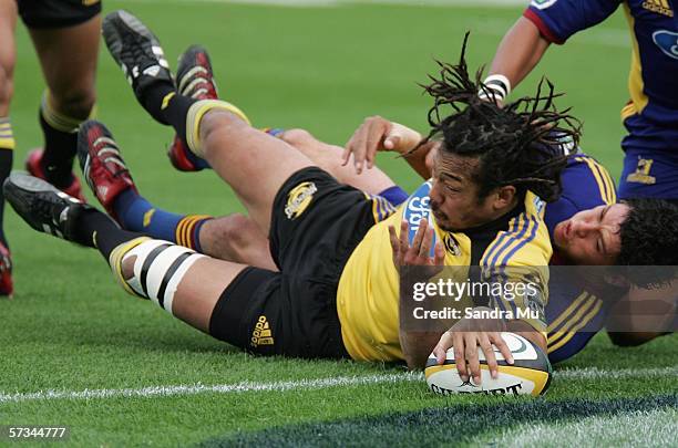 Tana Umaga of the Hurricanes presses the ball down to score a try during the round ten Super 14 match between the Highlanders and the Hurricanes at...