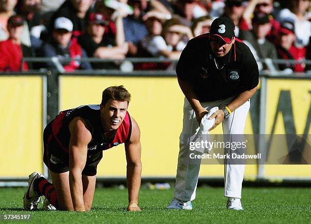 Matthew Lloyd for the Bombers is assisted by a trainer during the round three AFL match between the Essendon Bombers and the Western Bulldogs at the...