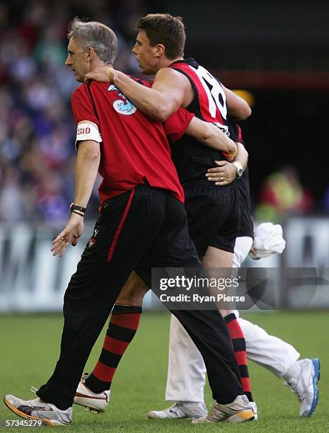 Matthew Lloyd of the Bombers leaves the ground after injuring his hamstring during the round three AFL match between the Essendon Bombers and the...