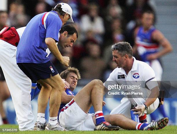 Adam Morgan of the Bulldogs looks in pain after injuring his knee during the round three AFL match between the Essendon Bombers and the Western...