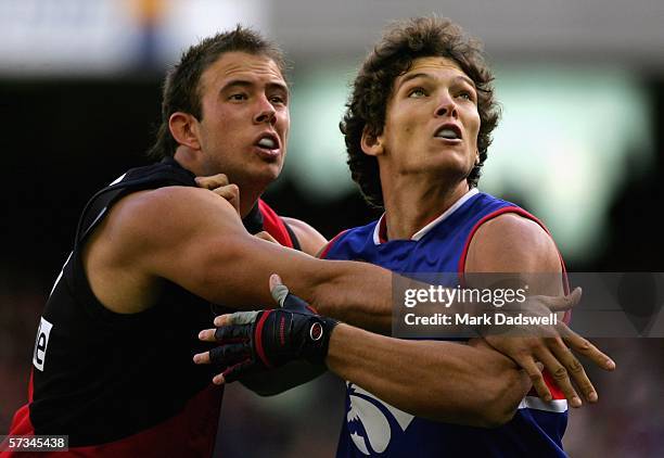 Kepler Bradley for the Bombers contests a boundary throw in with Will Minson for the Bulldogs during the round three AFL match between the Essendon...