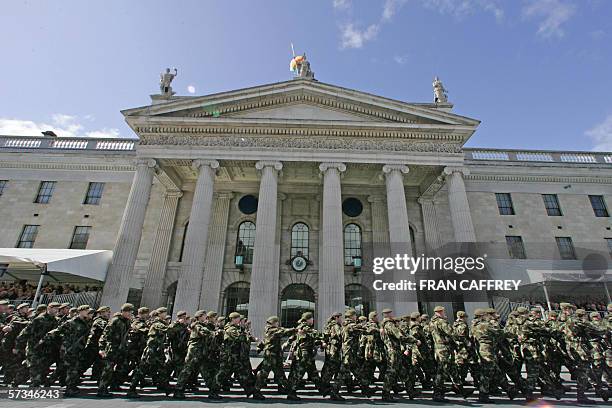 Troops march, in front of the Dublin General Post Office in O'Connell Street, 16 April 2006 during the major military parade to mark the 90th...