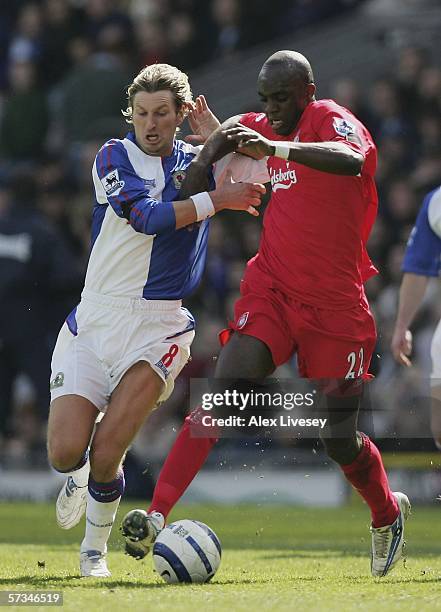 Momo Sissoko of Liverpool holds off a challenge from Robbie Savage of Blackburn Rovers during the Barclays Premiership match between Blackburn Rovers...