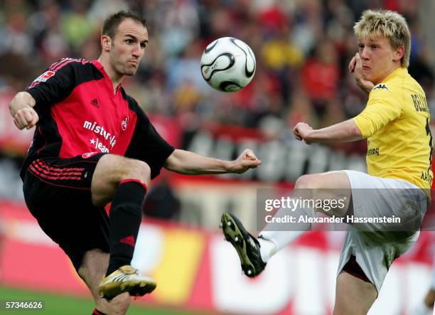 Robert Vittek of Nuremberg challenge for the ball with Axel Bellinghausen of Kaiserslautern during the Bundesliga match between 1.FC Nuremberg and...