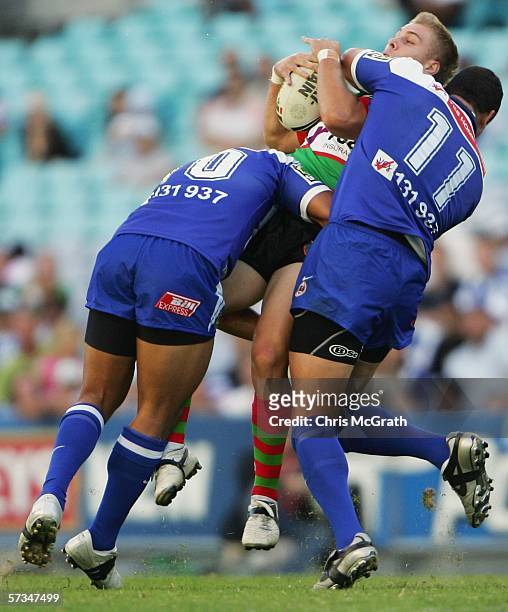 Shannon McPherson of the Rabbitohs is up ended by Willie Mason of the Bulldogs during the round six NRL match between the Bulldogs and the South...