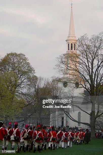 Re-enactors of the Battle of Lexington dressed as British soldiers march in formation after battling the Minute Men April 17, 2006 in Lexington,...