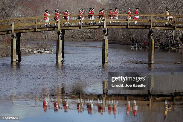 Re-enactors dressed as British soldiers march on the North Bridge over the Concord River after battling the minutemen April 17, 2006 in Concord,...