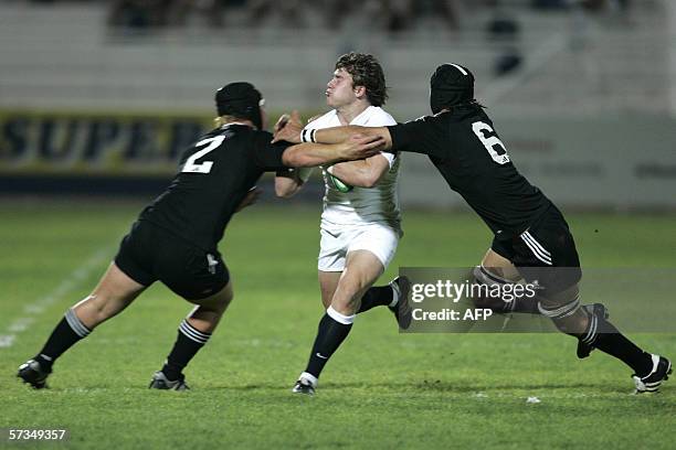 Dubai, UNITED ARAB EMIRATES: England's winger Tom Youngs can't get through New Zealand's hooker Mason Pomare and flanker Hoani Matenga , during a...