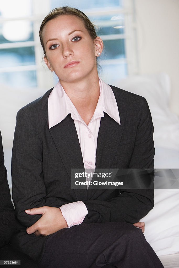 Portrait of a businesswoman sitting on a bed