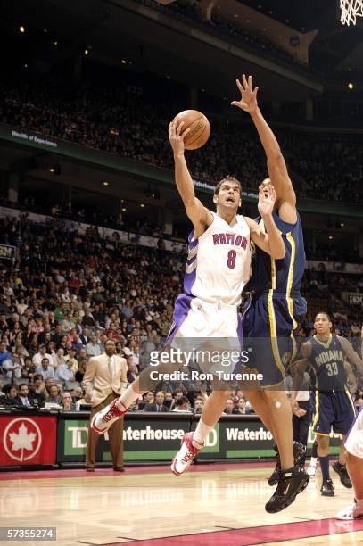 Jose Calderon of the Toronto Raptors drives deep against David Harrison of the Indiana Pacers on April 17, 2006 at the Air Canada Centre in Toronto,...