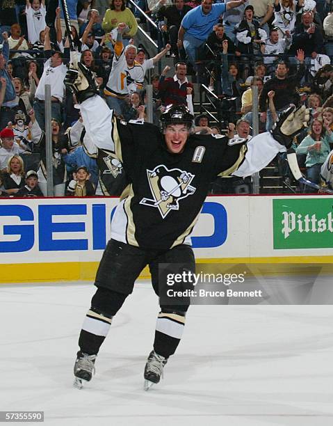 Sidney Crosby of the Pittsburgh Penguins celebrates after becoming the youngest player in NHL history to score 100 points in a season during a game...