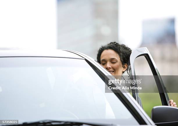 woman getting into car - entering ストックフォトと画像