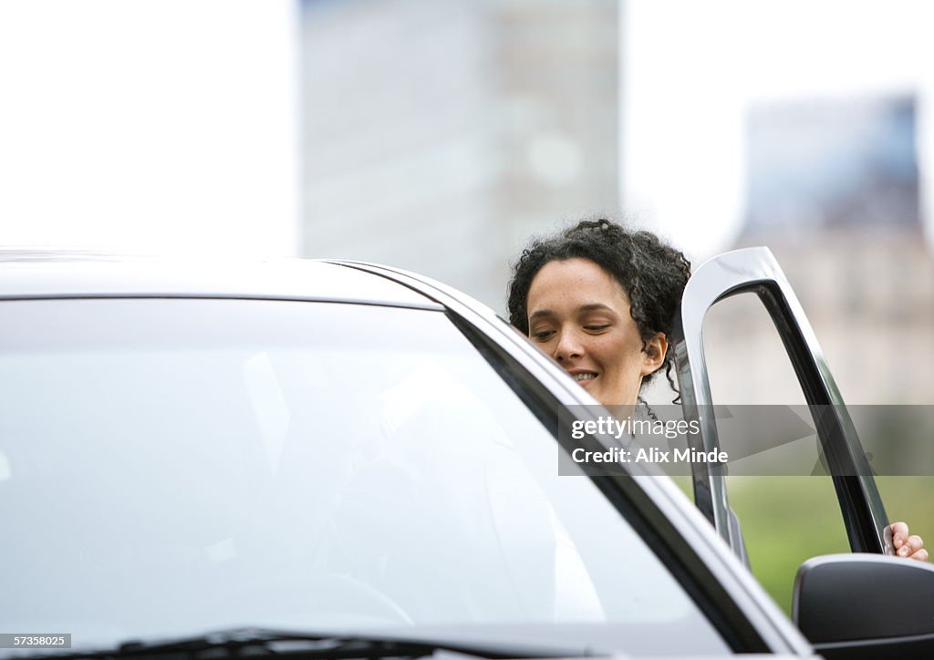 Woman getting into car