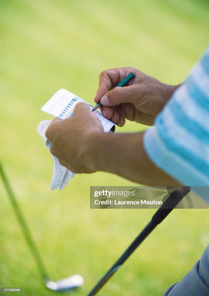 Golfer keeping score, close-up