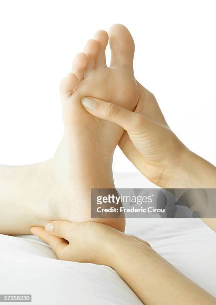 foot massage - barefoot girl stock-fotos und bilder