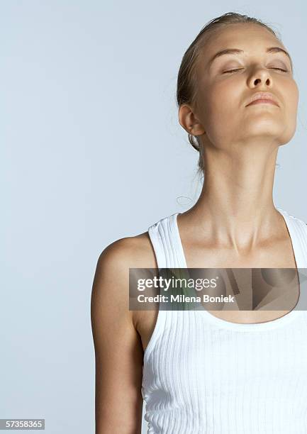 woman with eyes closed and head back - unterhemd stock-fotos und bilder