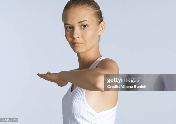 woman with arm bent in front of chest - teenage girl tai chi stock pictures, royalty-free photos & images