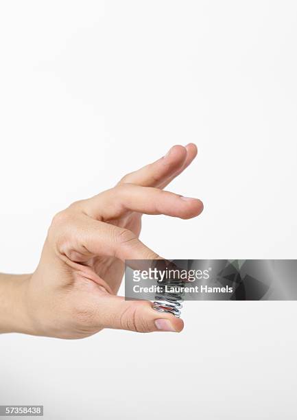 hand holding spring - metal fingers stock pictures, royalty-free photos & images